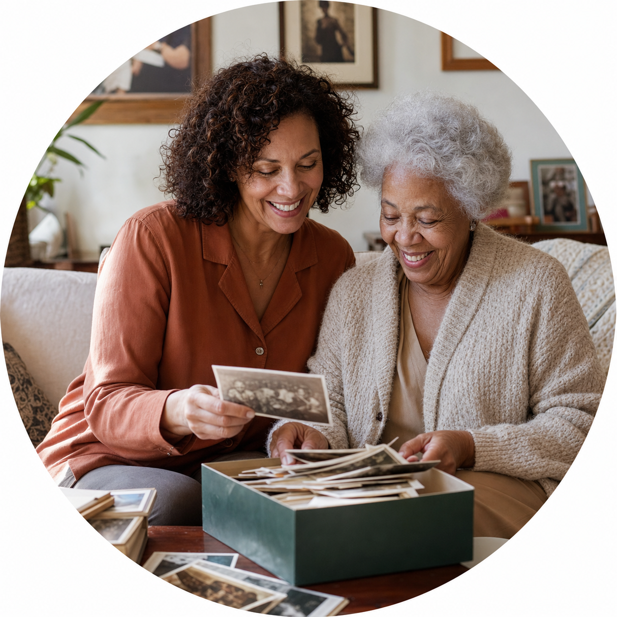 Adult daughter and mother looking through family photographs